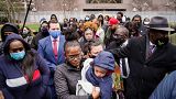 Chyna Whitaker, center, holds her son Daunte Jr., as she walks up to microphones to speak during a news conference, April 13, 2021, in Minneapolis.