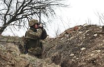 A Ukrainian soldier is seen at fighting positions on the line of separation from pro-Russian rebels near Donetsk, Ukraine, Monday, April 12, 2021. 