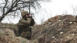 A Ukrainian soldier is seen at fighting positions on the line of separation from pro-Russian rebels near Donetsk, Ukraine, Monday, April 12, 2021.
