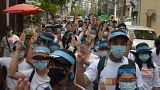 Anti-coup protesters flash the three-fingered salute while wearing headbands that read R2P (Responsibility to Protect), in Ahlone township in Yangon, Myanmar, April 12, 2021.