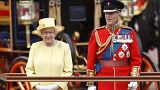 Britain's Queen Elizabeth II, and Prince Philip take a salute as the Guards march past outside Buckingham Palace on June 16, 2012.