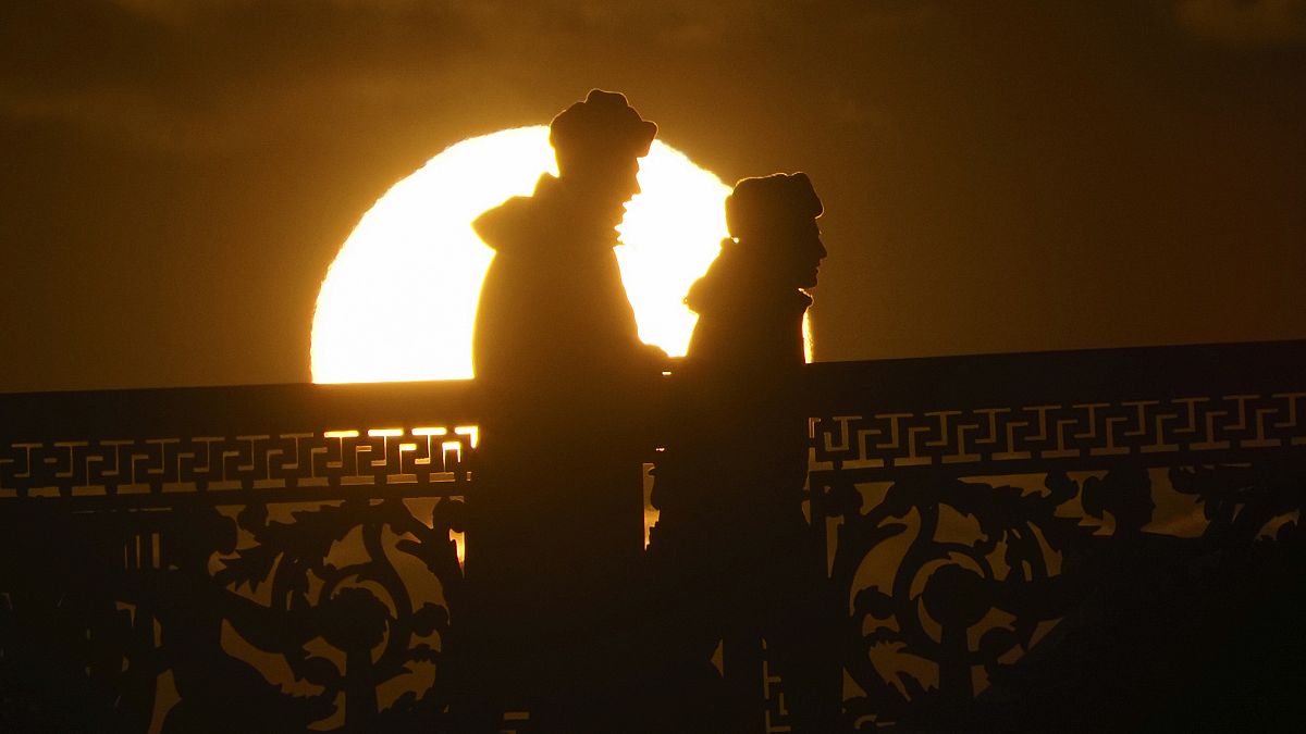 Russian soldiers silhouetted by the setting sun in downtown St. Petersburg, Russia, Friday, March 20, 2020. ((AP Photo/Dmitri Lovetsky)