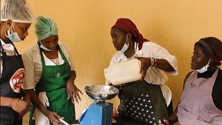 Fatoumata is weighing flour at a baking class in Conakry, Guinea.