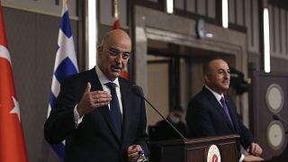 Greek Foreign Minister Nikos Dendias gestures as he talks during a joint media statement with Turkish Foreign Minister Mevlut Cavusoglu