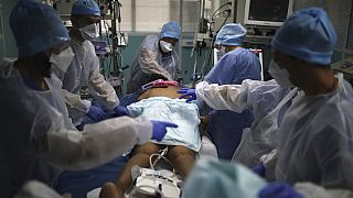 a medical crew gathers around a patient affected with COVID-19 in a Marseille hospital, southern France