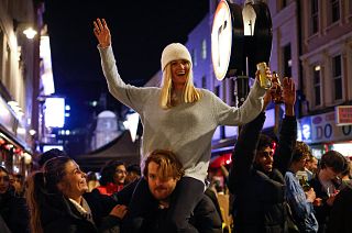 People drink in the street in the Soho area of London as COVID-19 restrictions are eased in step two of the government's roadmap out of England's third national lockdown