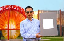 Xiulin Ruan, a Purdue University professor of mechanical engineering, holds up his lab’s sample of the whitest paint on record.