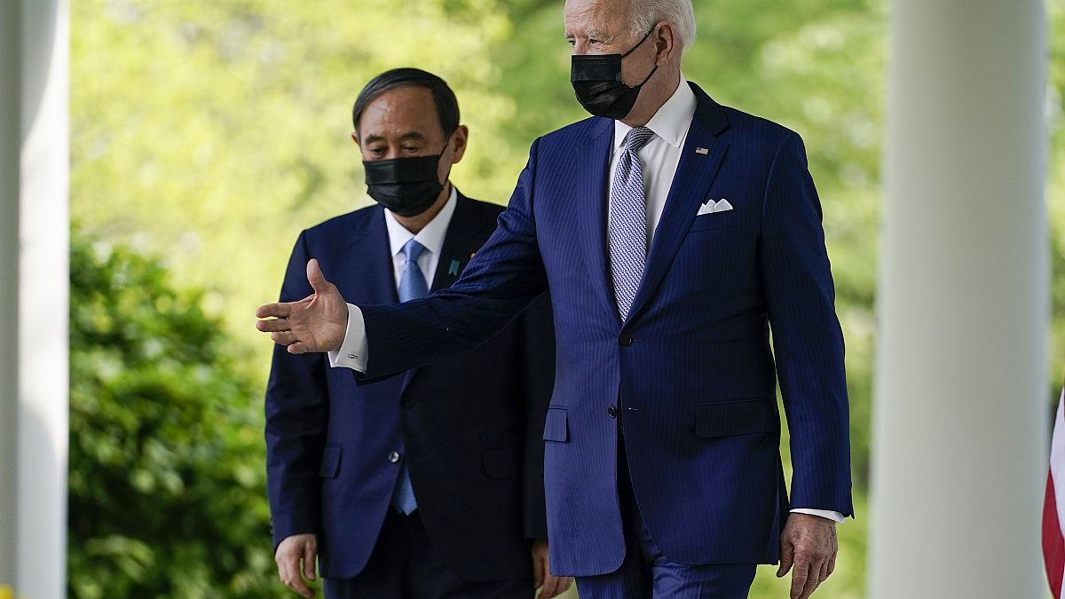 President Joe Biden, accompanied by Japanese Prime Minister Yoshihide Suga, walks from the Oval Office to speak at a news conference in the Rose Garden of the White House.