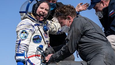 Expedition 64 NASA astronaut Kate Rubins is helped out of the Soyuz MS-17 spacecraft