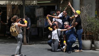 People pose for a picture on a street in Jerusalem after Israeli authorities announced that face masks were no longer required outdoors.