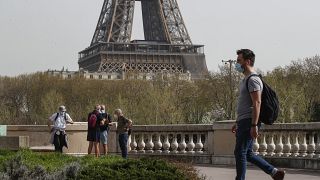 A man wearing a mask crosses the Bir Hakeim bridge in Paris, Thursday, April 1, 2021.