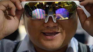 A man wears virtual reality glasses