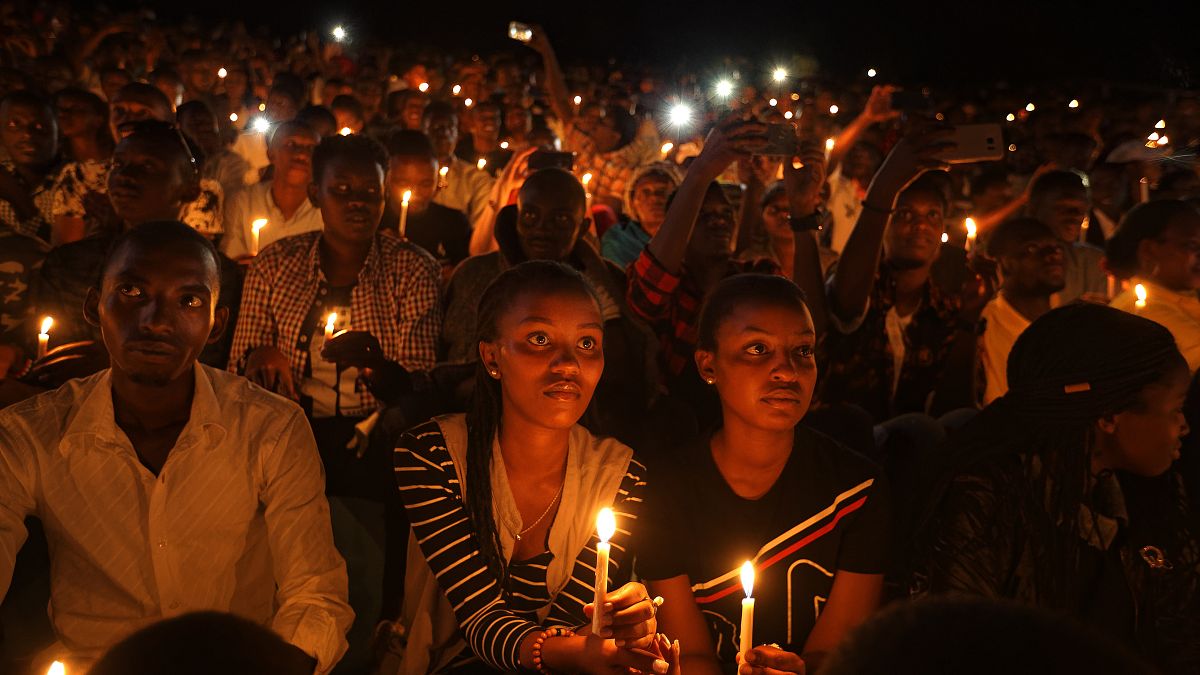 In this Sunday, April 7, 2019 file photo, people attend a candlelit vigil during a memorial service marking 25 years since the genocide, in Kigali, Rwanda.