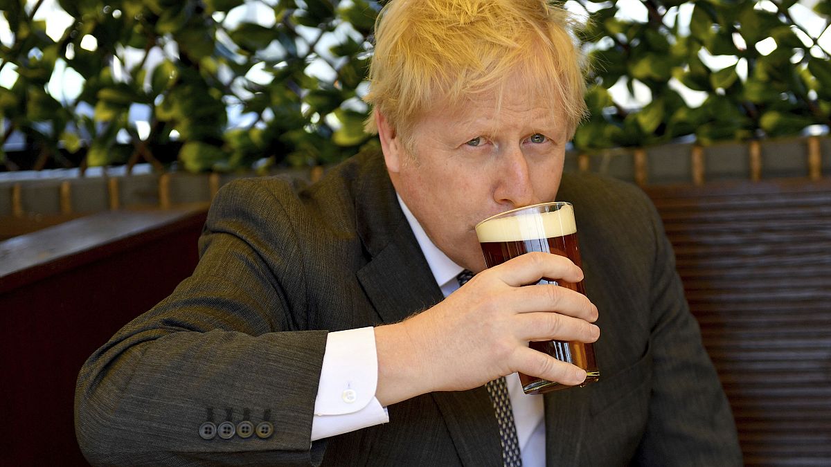 رئيس الوزراء البريطاني بوريس جونسون يرتشف كأس من البيرة في حانة في ولفرهامبتون بوسط إنجلترا.