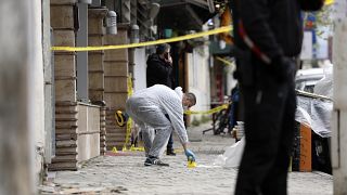 A policeman investigates the area outside Dine Hoxha mosque in Tirana.