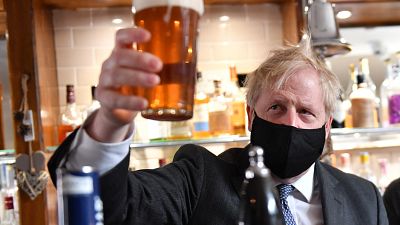 Britain's Prime Minister poses after he poured a pint of beer at during a visit to The Mount Tavern pub and restaurant in Wolverhampton.
