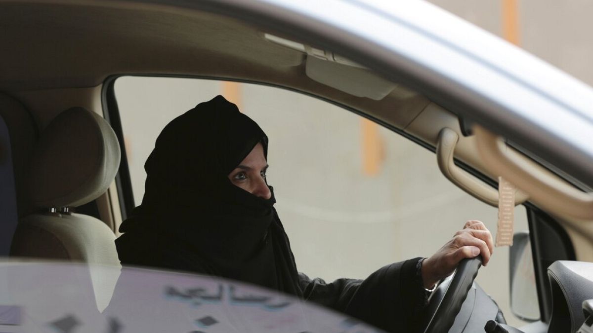 FILE - In this March 29, 2014 file photo, Aziza al-Yousef drives a car on a highway during a women's rights campaign in Riyadh, Saudi Arabia. 