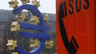 An emergency phone at a tram stop stands near the Euro sculpture in front of the European Central Bank in Frankfurt, Germany, March 18, 2014. 