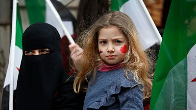 A child stands during a rally in Istanbul on Thursday, February 22, 2018, against attacks on the suburb of eastern Ghouta in Syria's capital Damascus. A child stands during a rally in Istanbul on Thursday, February 22, 2018, against attacks on the suburb of eastern Ghouta in Syria's capital Damascus.