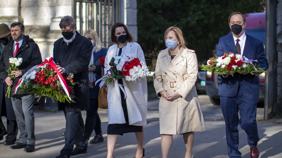 Belarus opposition leader Sviatlana Tsikhanouskaya, centre, and U.S. Ambassador to Belarus Julie Fisher attend a memorial service for Chernobyl victims in Vilnius, Lithuania