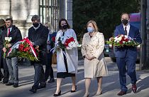 Belarus opposition leader Sviatlana Tsikhanouskaya, centre, and U.S. Ambassador to Belarus Julie Fisher attend a memorial service for Chernobyl victims in Vilnius, Lithuania