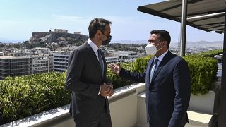 Greece's Prime Minister Kyriakos Mitsotakis, left, speaks with his North Macedonian counterpart Goran Zaev