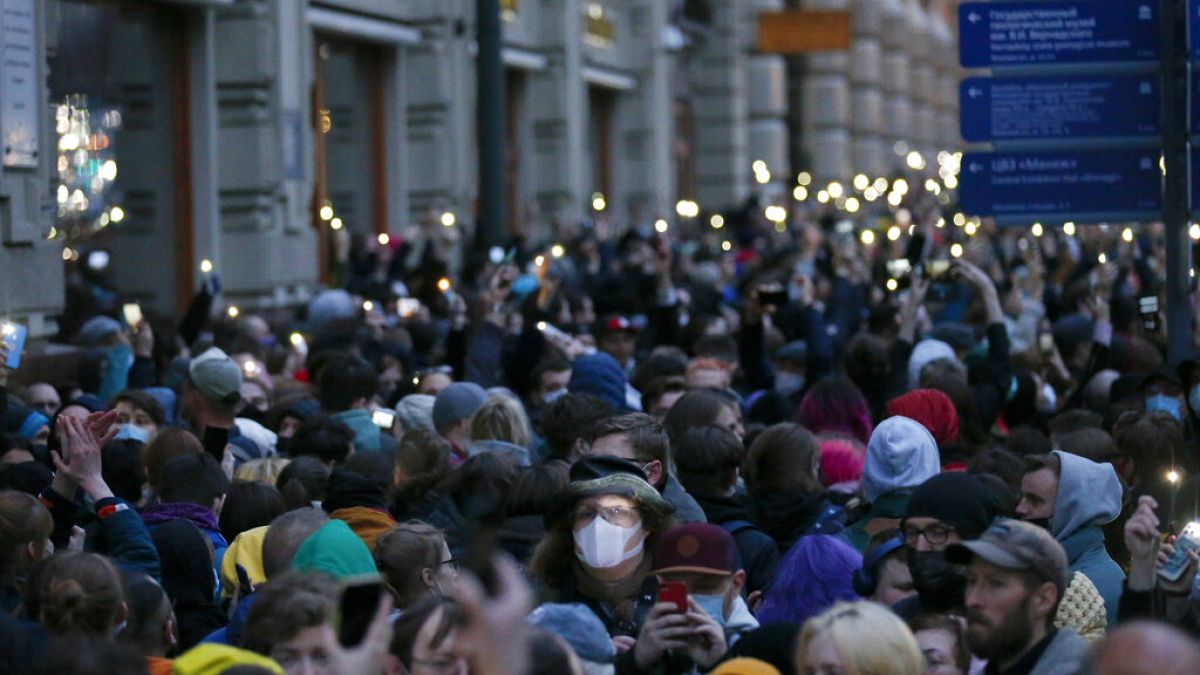 People light their phones during the opposition rally in support of jailed opposition leader Alexei Navalny in Moscow, Russia, Wednesday, April 21, 2021.