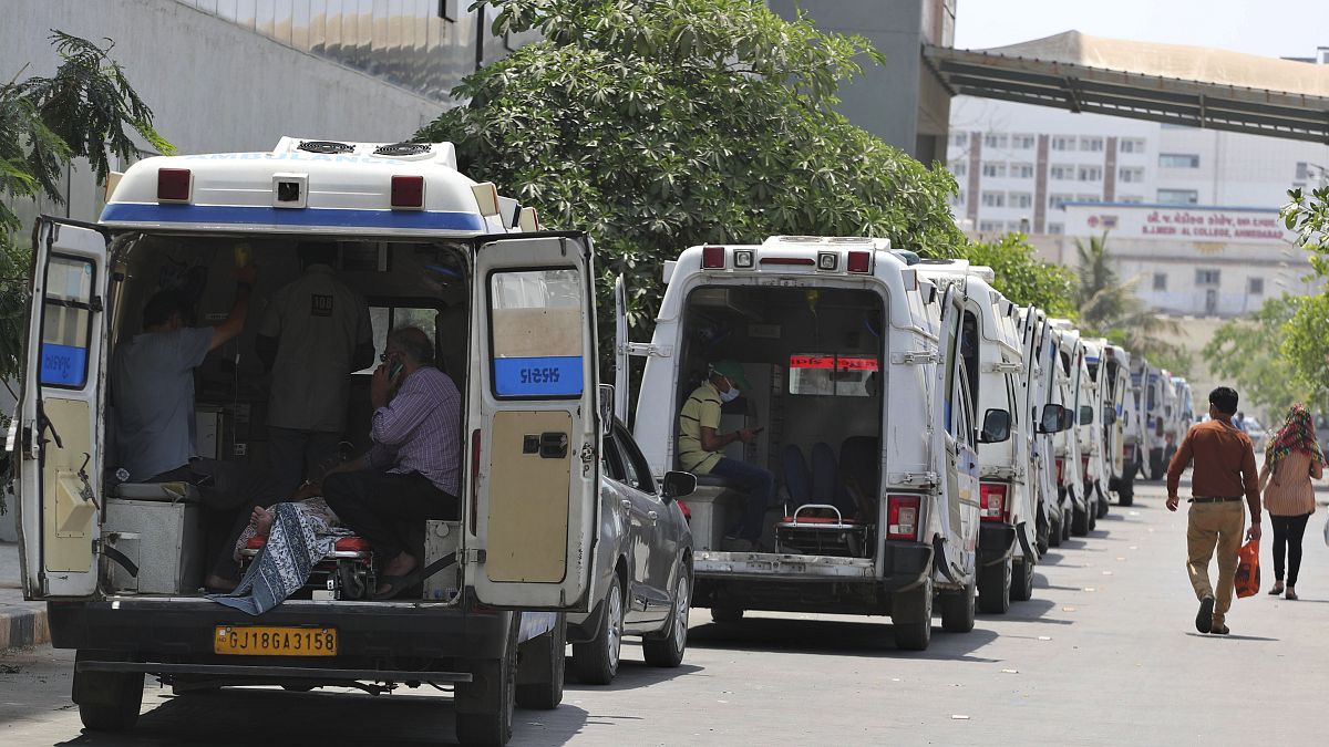 Ambulances carrying COVID-19 patients line up waiting for their turn to be attended at a dedicated COVID-19 government hospital in Ahmedabad, India