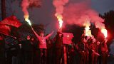 Supporters of the Socialist Movement for Integration (LSI) hold flares during a rally of their party in Tirana, Albania, Thursday, April 22, 2021.