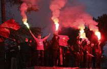 Supporters of the Socialist Movement for Integration (LSI) hold flares during a rally of their party in Tirana, Albania, Thursday, April 22, 2021.