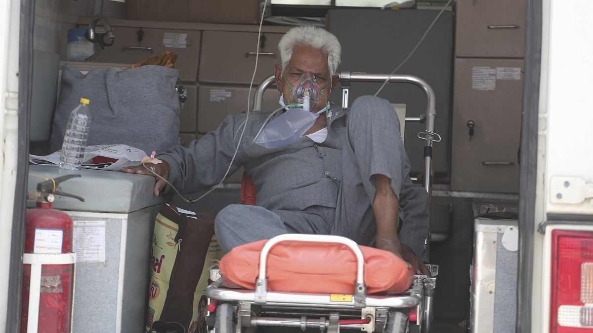 A COVID-19 patient waits inside an ambulance to be attended to and admitted into a dedicated COVID-19 government hospital in Ahmedabad, India.