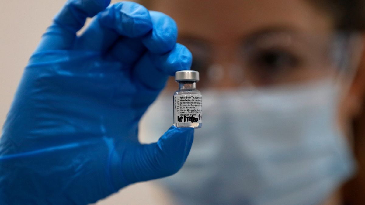 A nurse holds a phial of the Pfizer COVID-19 vaccine at Guy's Hospital in London, Tuesday, Dec. 8, 2020. 
