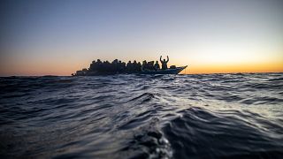File photo of migrants on an overcrowded boat awaiting assistance off the Libyan coast