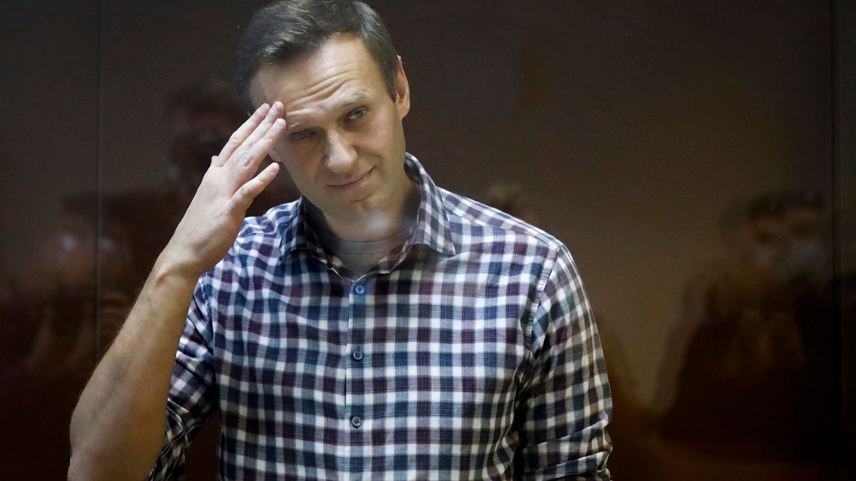 Russian opposition leader Alexei Navalny stands in a cage in the Babuskinsky District Court in Moscow, Russia, Feb. 20, 2021.