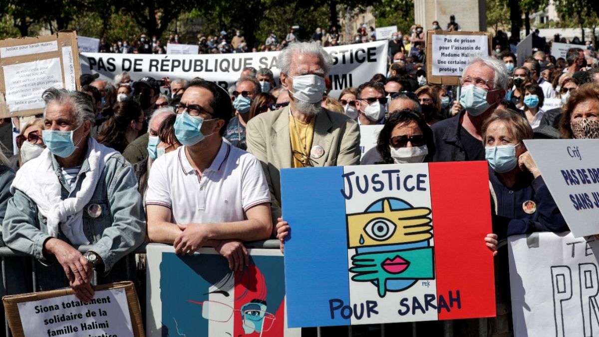 A woman holds a placard reading "Justice for Sarah" as people gather to ask justice for late Sarah Halimi on Trocadero plaza in Paris on April 25, 2021