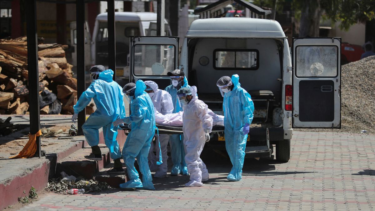 عاملون في قطاع الصحة بالهند ينقلون جثة شخص توفي جراء إصابته بفيروس كورونا إلى المحرقة في إقليم جامو يوم الأحد 25 نيسان/أبريل 2021