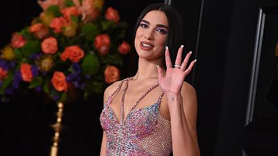 Dua Lipa called for a pay rise for UK healthcare workers at the 2021 BRIT Awards. In this Sunday, 14 March, 2021 file photo she arrives at the 63rd annual Grammy Awards.