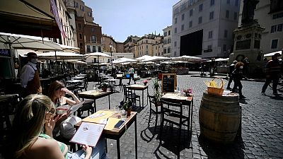 People take a lunch in a restaurant in Campo dei Fiori square in downtown Rome