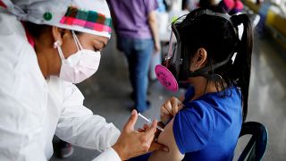 A COVID vaccine is administered in Honduras