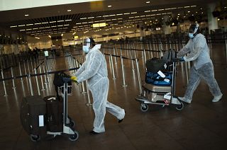 Passengers, wearing full protective gear at Zaventem international airport in Brussels on July 29, 2020.