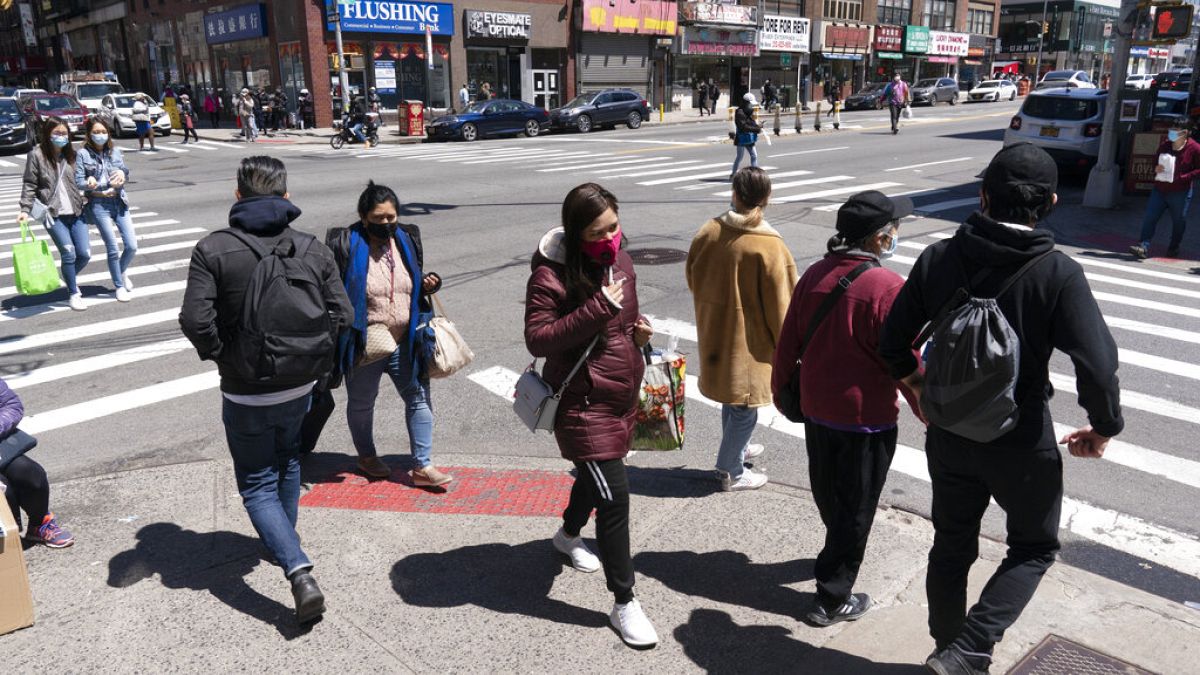 People walk on the street, Monday, April 26, 2021 in New York