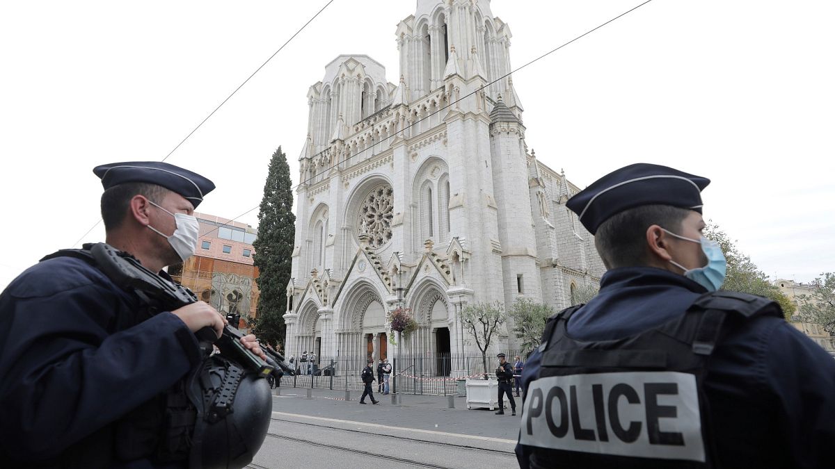 police officers stand guard near Notre Dame church in Nice, southern France on October 29, 2020. 