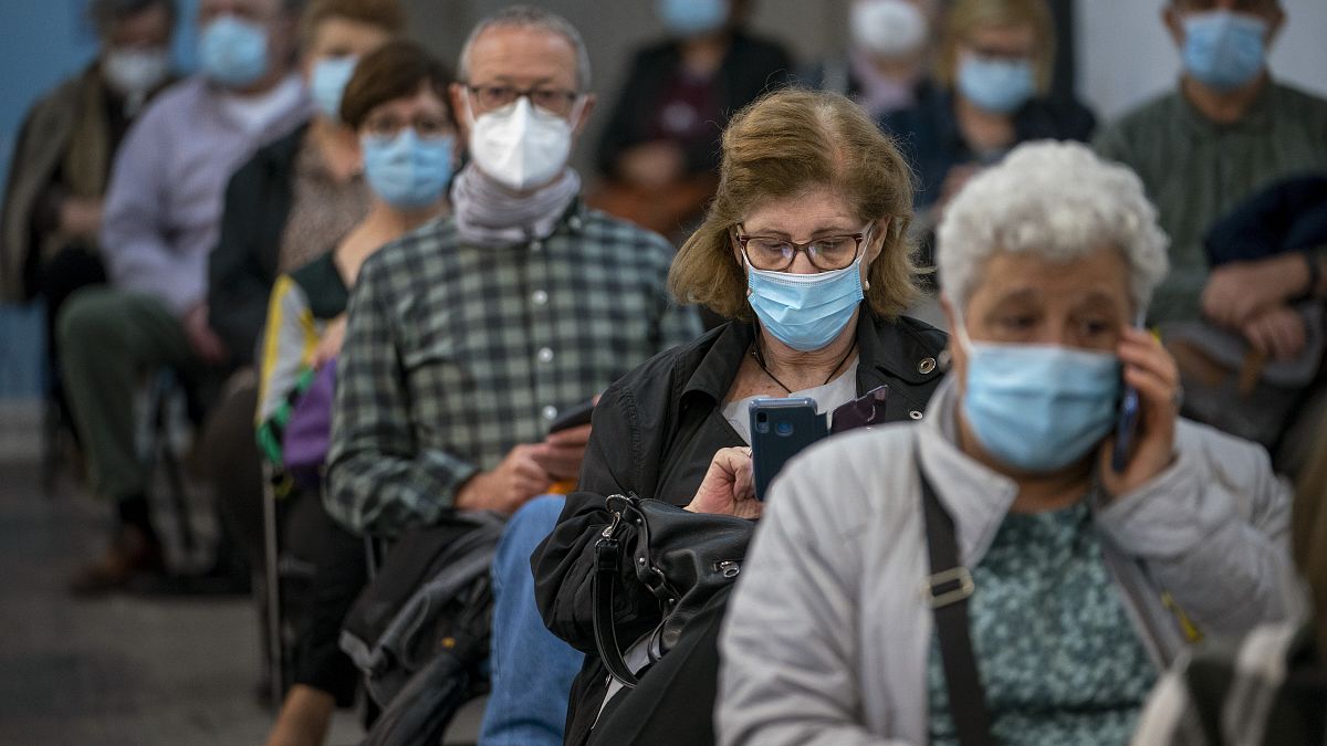 People wait after receiving the AstraZeneca vaccine at a temporally vaccination centre at the Fira of Barcelona, Spain, Monday, April 26, 2021.