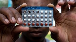 A woman holds a packet of contraceptive pills, in Harare, April 9, 2020 as COVID-19 lockdowns have prevented millions of women globally from accessing contraceptives. 