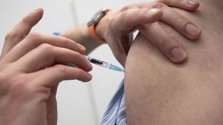 An employee of the Tuebingen Vaccination Centre inoculates a dose of Biontech vaccine in the Paul Horn Arena in Tuebingen, Germany, Wednesday, April 21, 2021.