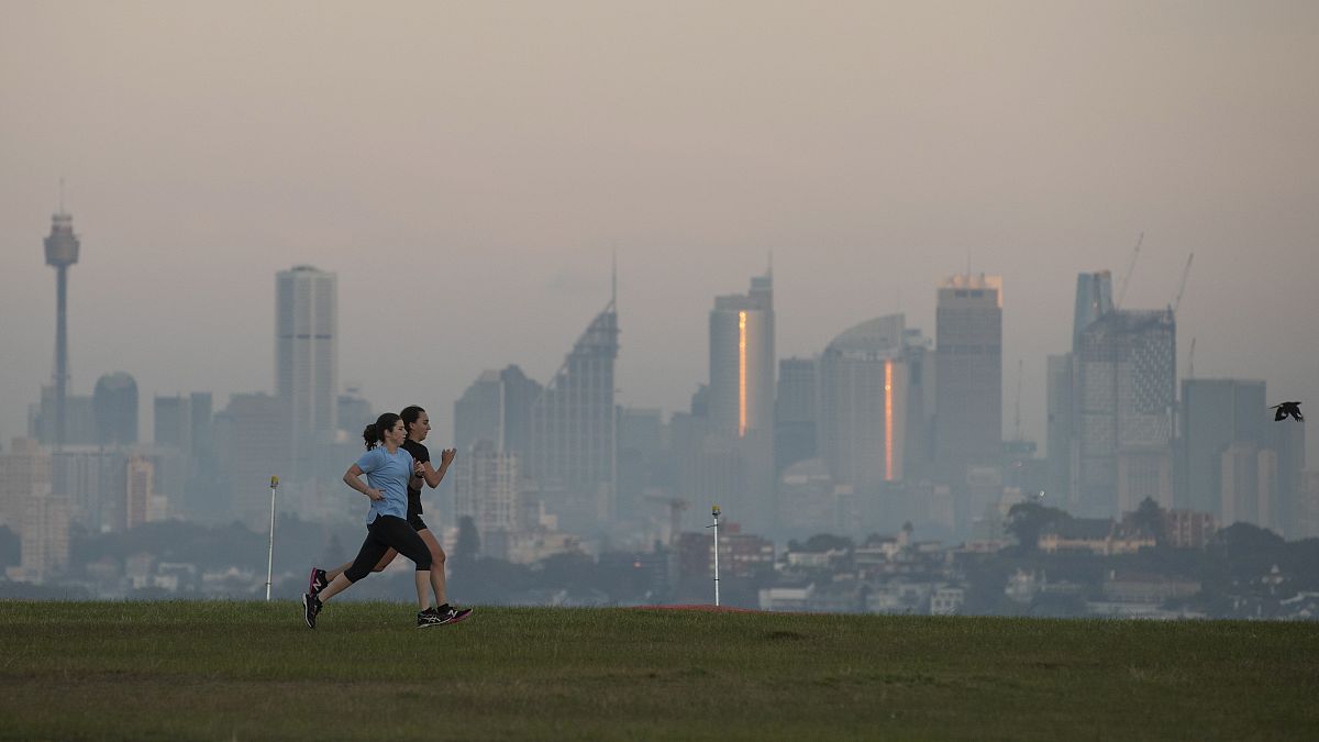 People exercise at a park as the sun rises in Sydney, Australia, Wednesday, April 28, 2021.