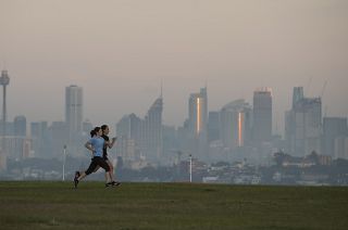 People exercise at a park as the sun rises in Sydney, Australia, Wednesday, April 28, 2021.