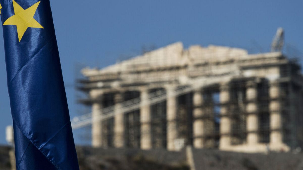  European Union flag is seen in front of the ancient parthenon temple at the Acropolis hill in Athens