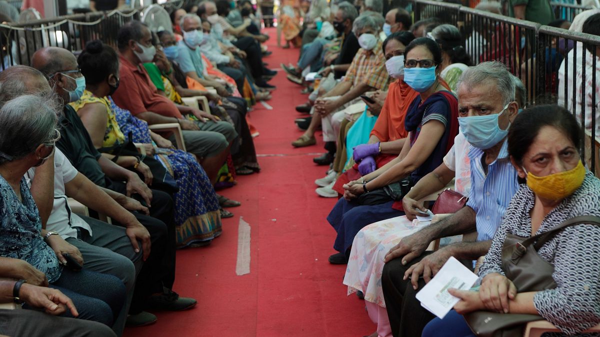 People wait to receive COVID-19 vaccine in Mumbai, India, Thursday, April 29, 2021.
