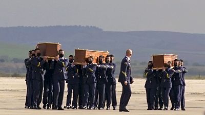 Coffins carrying the bodies of the victims arrived from Burkina Faso at Madrid's military airport on Friday. Coffins carrying the bodies of the victims arrived from Burkina Faso at Madrid's military airport on Friday.